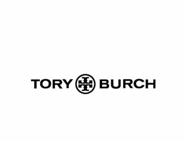 The image shows the Tory Burch logo with TORY and BURCH in bold black letters, separated by a circular emblem featuring a geometric design, all set against a white background.