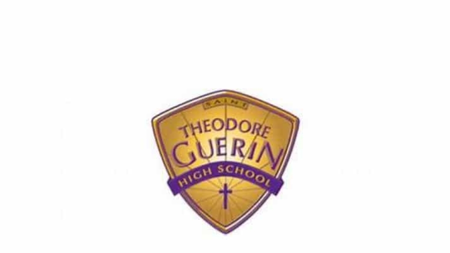 A gold and purple shield logo reads Saints Theodore Guerin High School with a small cross at the bottom.
