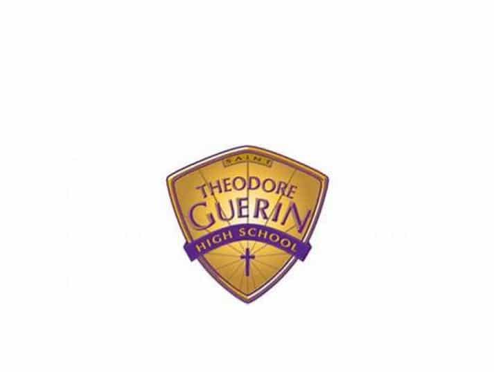 A gold and purple shield logo reads Saints Theodore Guerin High School with a small cross at the bottom.