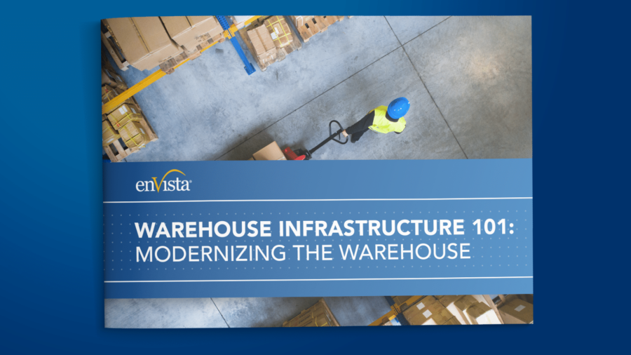 A brochure cover titled Warehouse Infrastructure 101: Modernizing the Warehouse shows an aerial view of a worker in a safety vest and helmet moving boxes with a pallet jack in a warehouse.