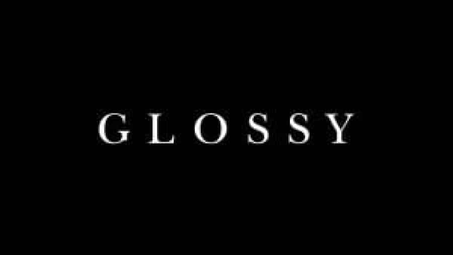 The word GLOSSY is centered in white, all-caps serif font on a solid black background.