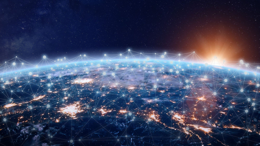 View of Earth from space at sunrise, showing bright city lights and a network of connected points and lines across the surface, symbolizing global communication and connectivity.