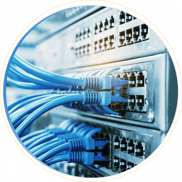 Close-up of blue Ethernet cables plugged into network switches on a server rack, representing internet or data connections and efficient network management in a technological or IT environment.