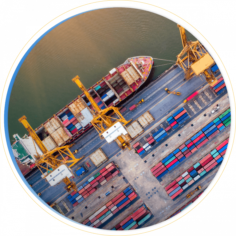 Aerial view of a cargo ship docked at a port, surrounded by colorful shipping containers and yellow cranes—an efficient scene powered by D365 Supply Chain Management along the waterfront.