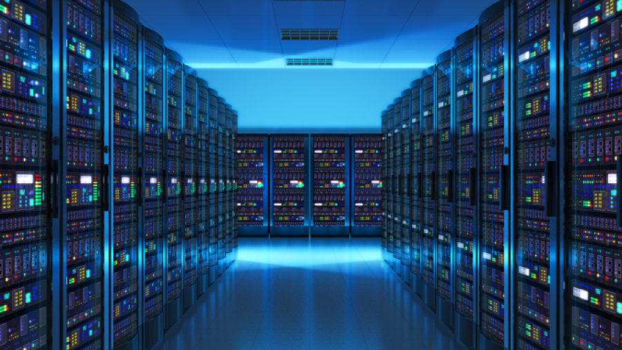 A brightly lit, modern data center with rows of server racks on both sides, glowing with colorful lights, showcases advanced cloud managed services along a polished reflective floor leading to more servers at the far end.