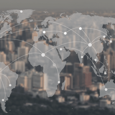 A faint world map overlay with connected white dots represents global communication or networking, set against a blurred city skyline in the background.