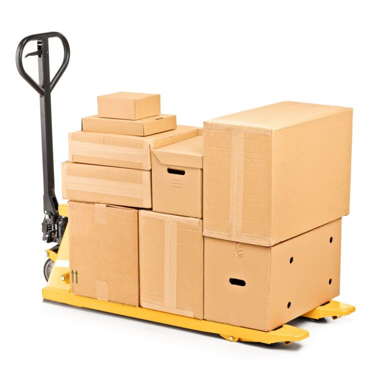 A yellow pallet jack loaded with various sizes of cardboard boxes, stacked neatly and secured with tape, demonstrates Lean process improvements, isolated on a white background.