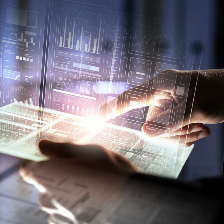A person’s hand interacts with a glowing, transparent tablet displaying digital graphs and charts, with futuristic data visualizations projected in the background.