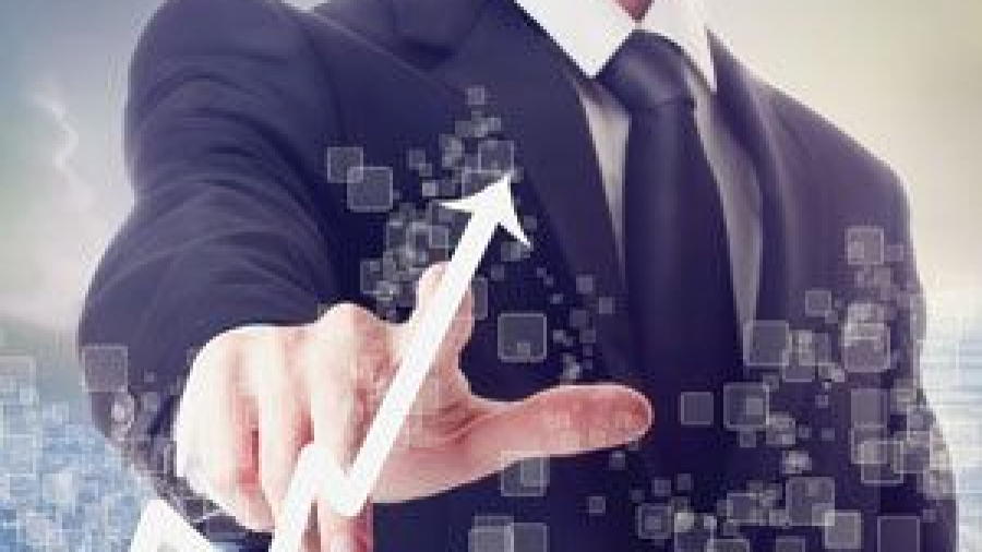 A man in a business suit touches a virtual screen displaying a rising white arrow, symbolizing growth or success in supply chain cost management, with digital squares in the background.