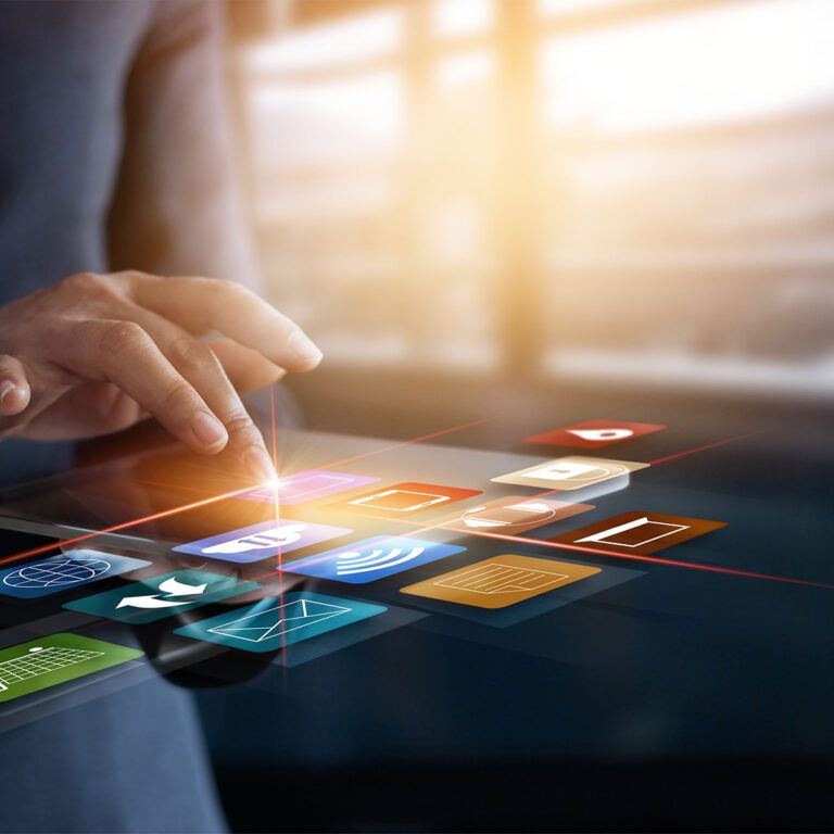 A person in a suit interacts with colorful floating digital icons, representing various apps and technologies like what is omnichannel fulfilment, against a blurred office background with large windows.