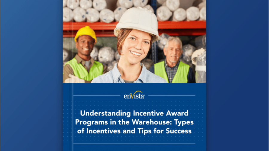 A smiling woman in a hard hat and safety vest stands in a warehouse with two male workers behind her. Text reads: Understanding Incentive Award Programs in the Warehouse: Types of Incentives and Tips for Success.