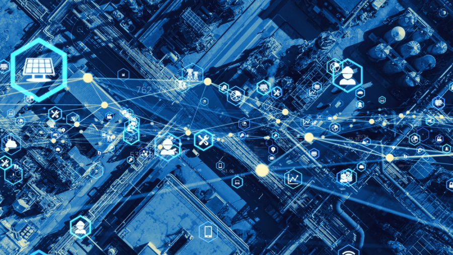 Aerial view of an industrial site overlaid with digital icons and lines representing data, connectivity, and supply chain optimization. The blue tint signifies a modern, connected industrial environment.