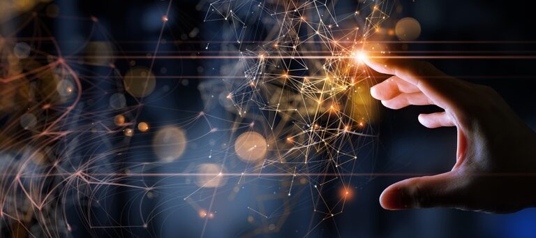 A hand reaches toward glowing interconnected points and lines, resembling a digital network or neural connections—much like the connectivity found in what is Microsoft Dynamics 365—set against a dark, abstract background with orange and blue light effects.