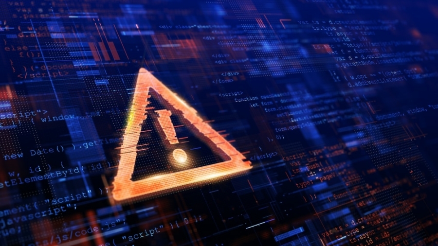 A glowing orange warning triangle with an exclamation mark appears over a digital background filled with computer code and circuit-like patterns, suggesting a cybersecurity threat or data breach.