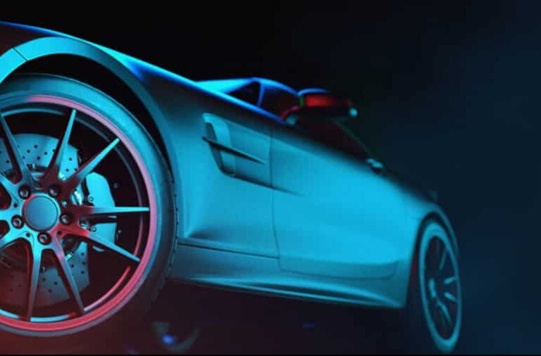 Close-up, low-angle view of the rear side of a sleek, modern sports car with dramatic blue and red lighting, highlighting its wheel, brake disc, and smooth metallic body—a true reflection of cutting-edge design and automation strategies.