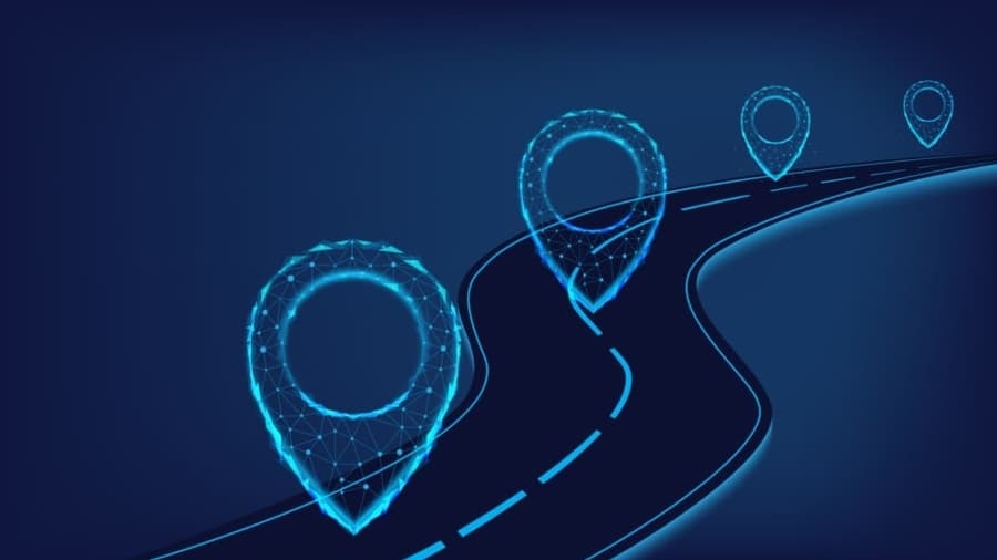 A dark blue digital illustration of a winding road with three glowing, futuristic location pins made of light and geometric lines placed along the route.