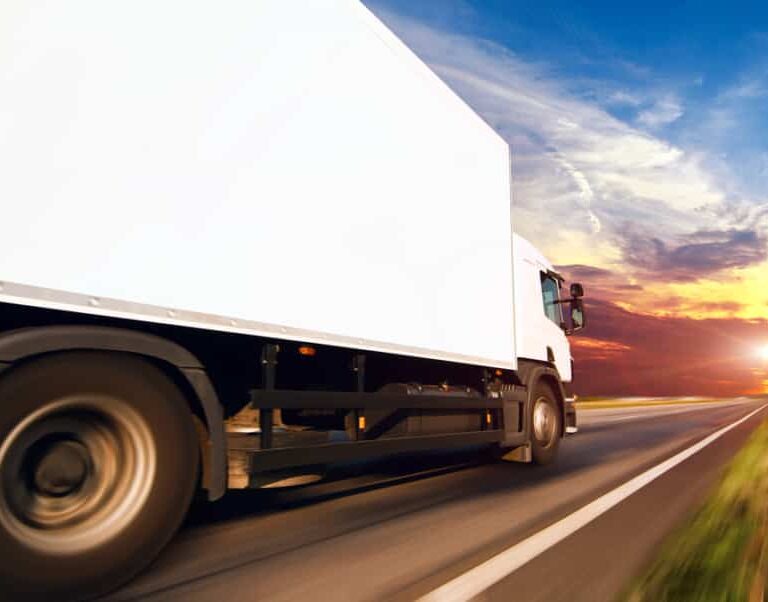 A truck equipped with advanced transportation software is driving on the road.