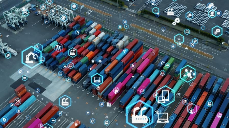 Aerial view of a shipping container yard with colorful containers and overlayed digital icons representing technology, logistics, and data connectivity in supply chain management.