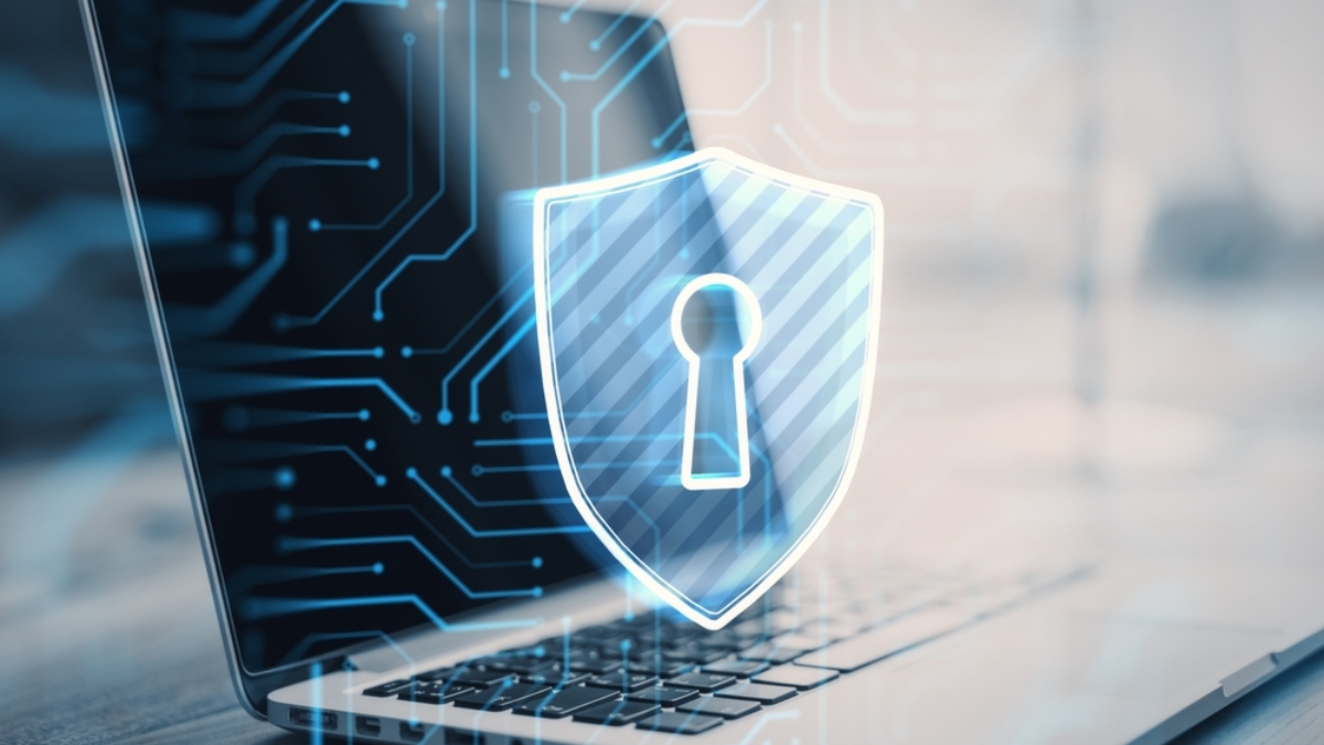 A laptop with a digital lock and shield icon overlay, symbolizing cybersecurity and data protection for Autonomous Mobile Robots, with circuit-like graphics in the background.