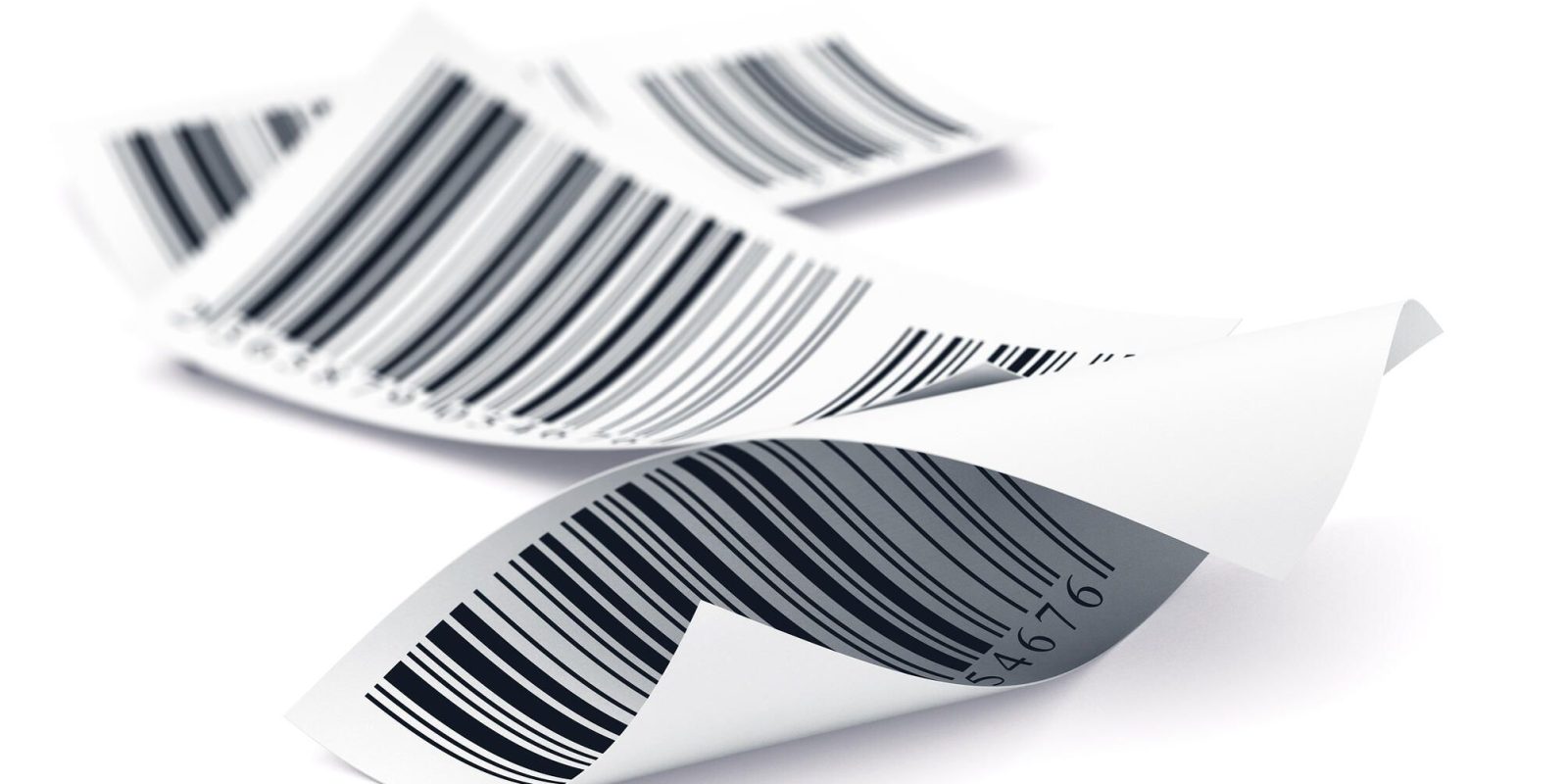 A close-up of several curled paper labels with printed barcodes, lying overlapping on a white background.