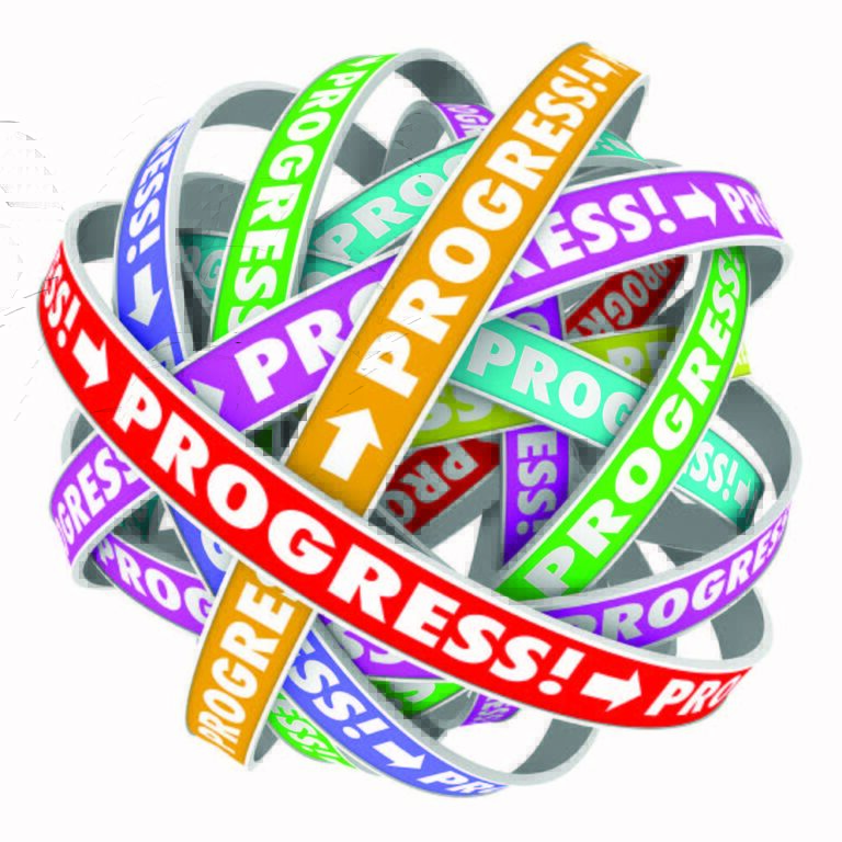 A tangled ball of colorful ribbons with the word “PROGRESS!” and arrows printed on each in various colors, symbolizing movement, advancement, and complexity.