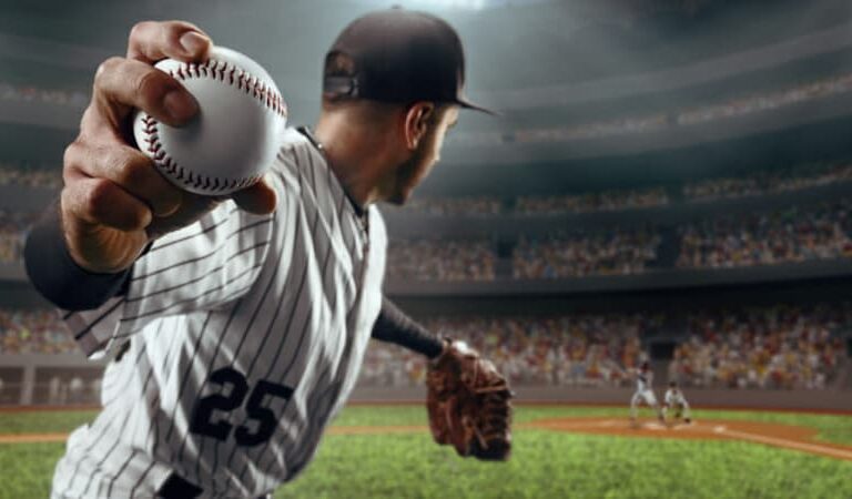 A baseball pitcher in a striped uniform, number 25, prepares to throw a pitch in a packed stadium, with blurred players and a cheering crowd in the background.