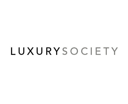 The image features the words LUXURY SOCIETY in a clean, modern font. LUXURY is in bold black letters, while SOCIETY is in light gray letters, all on a white background.