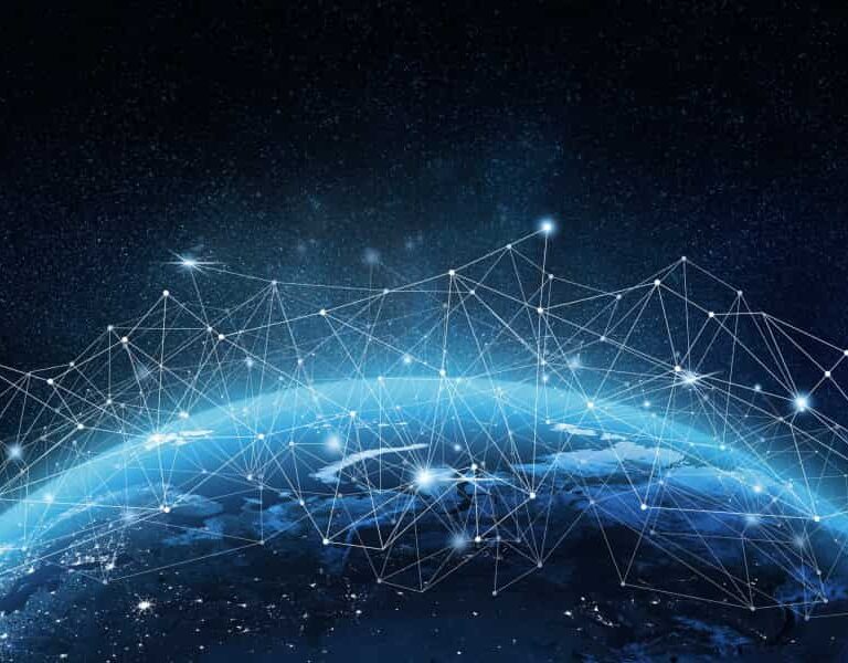 View of Earth from space with a network of glowing lines and points connecting across the surface, symbolizing global digital connectivity and data exchange on a dark, starry background.