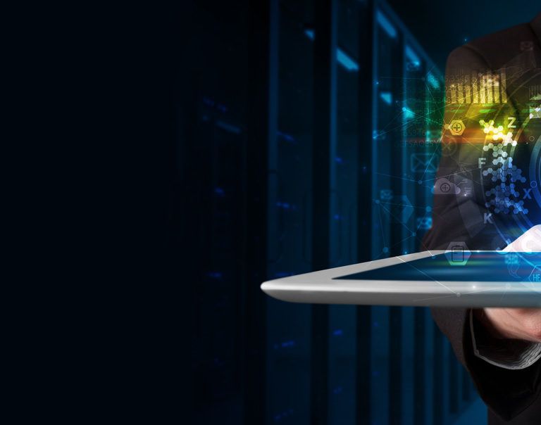 A person in a suit holding a tablet with a glowing cloud computing icon and digital data graphics hovering above it, symbolizing cloud technology and data management, with a dark server room background.