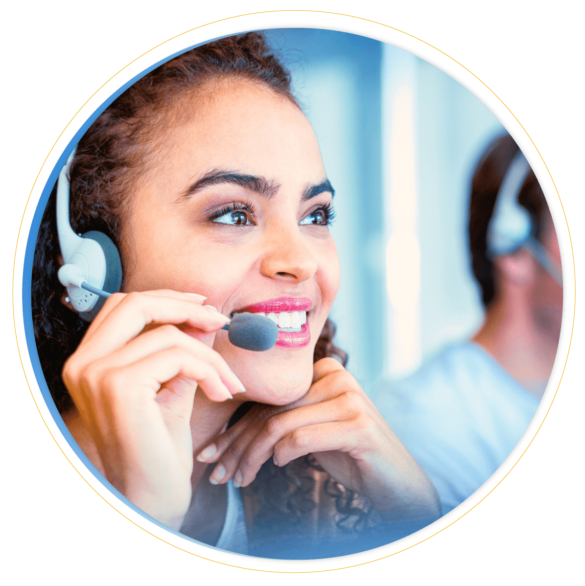 A smiling woman with curly hair wearing a headset is speaking, suggesting she is working in service desk management or a call center environment. Another person wearing a headset is visible in the background.