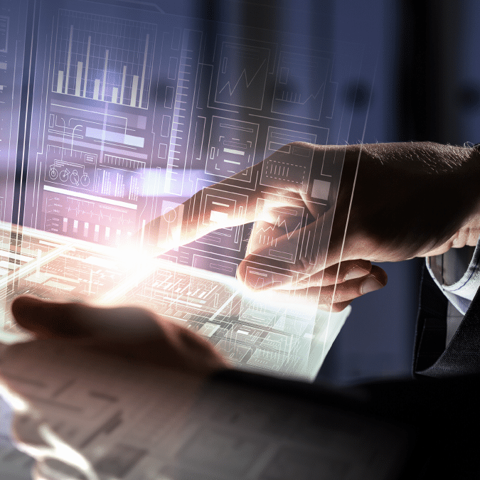 A person’s hands interact with a transparent touchscreen displaying digital charts, graphs, and data visualizations, suggesting futuristic technology and advanced data analysis.