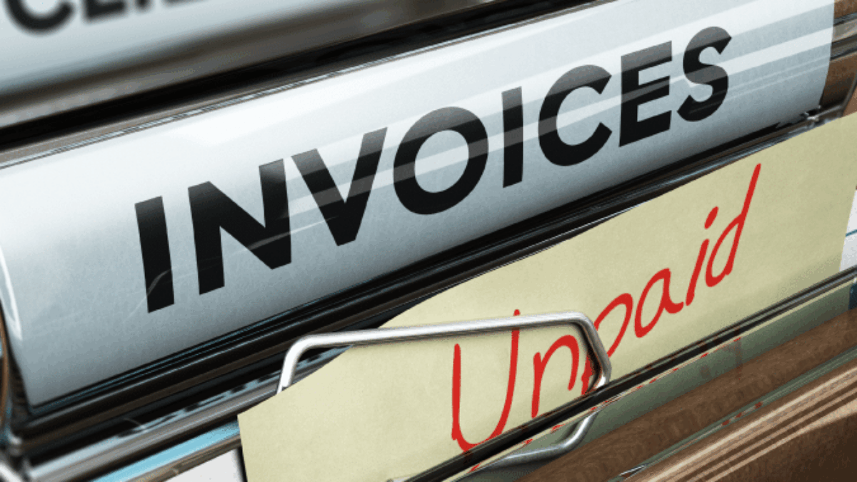 A file folder labeled INVOICES contains documents, including one marked Unpaid in red letters. Other folders labeled CLIENTS and COMP are partially visible in the background.