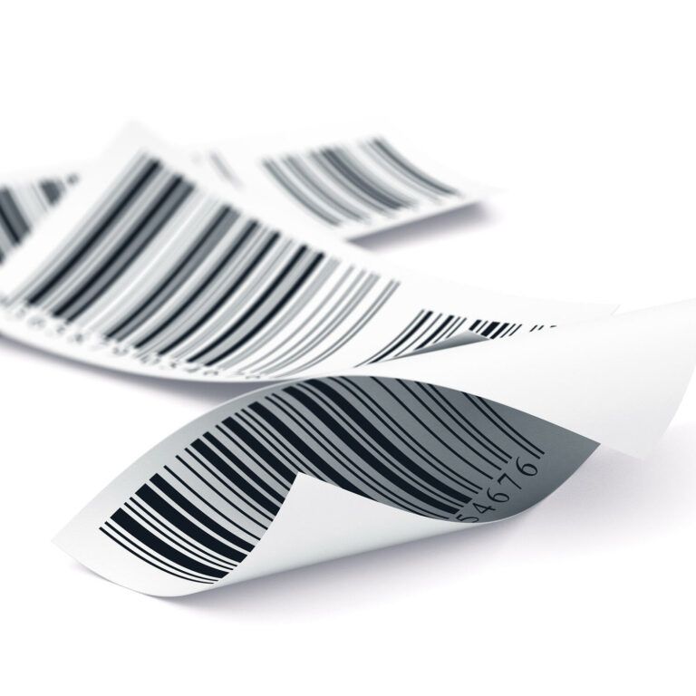 Three curled, white paper receipts with black barcodes are lying on a white surface, overlapping slightly.