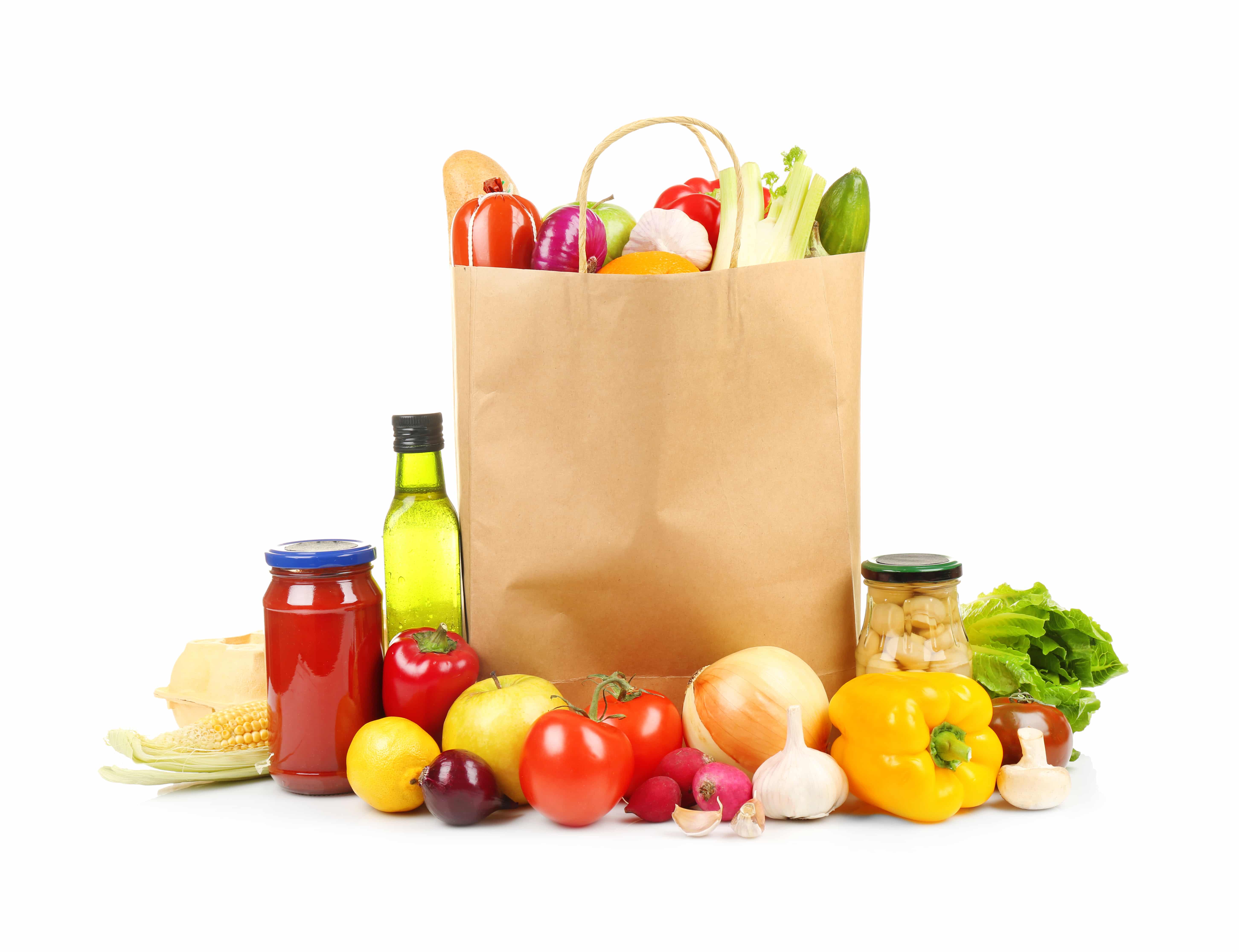 A paper grocery bag filled with fresh vegetables and bread sits on a white background, surrounded by produce like tomatoes and onions—ideal for showcasing effective distribution consulting in food retail.