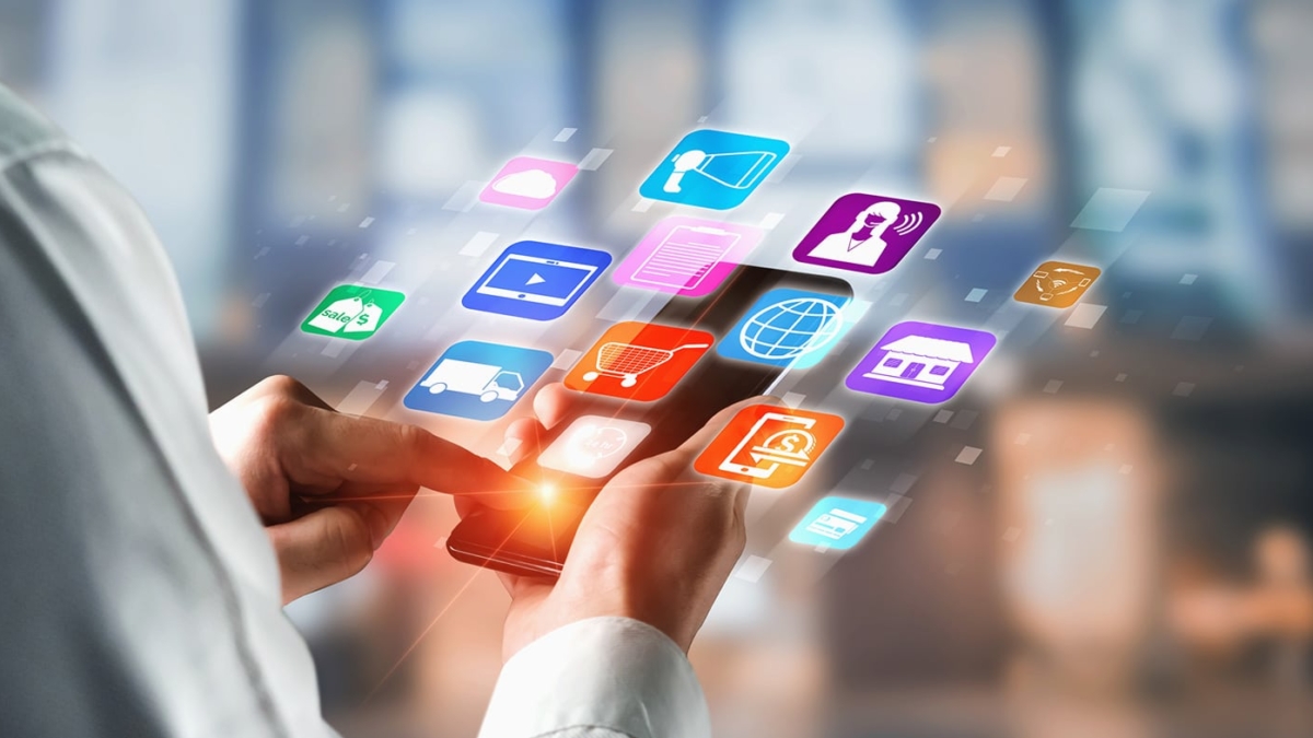 A person uses a smartphone with colorful digital app icons, including a shopping cart and retail OMS, floating above the screen, symbolizing technology and mobile applications.