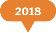 An orange speech bubble with a pointed tail at the bottom, containing the white text 2018 in bold font.