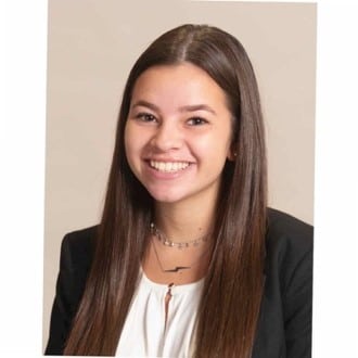 A woman with long hair smiling.