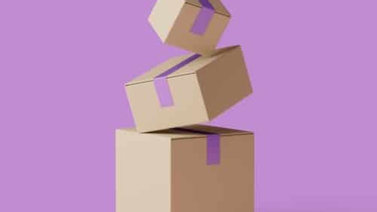 Three cardboard boxes with purple tape are stacked unevenly against a purple background, with the top box appearing to be in mid-air as if falling or being placed onto the others.
