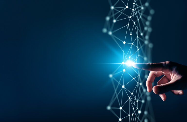 A hand reaching out to touch a glowing point on a digital network of connected lines and nodes, symbolizing technology, innovation, and the power of digital transformation consulting against a dark blue background.
