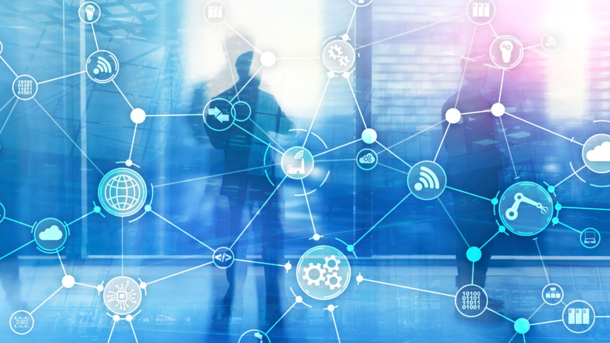 Silhouettes of business people stand in a modern office. A digital network of interconnected icons, including gears and graphs, is overlaid, symbolizing technology, data, supply chain execution software, and global connectivity.
