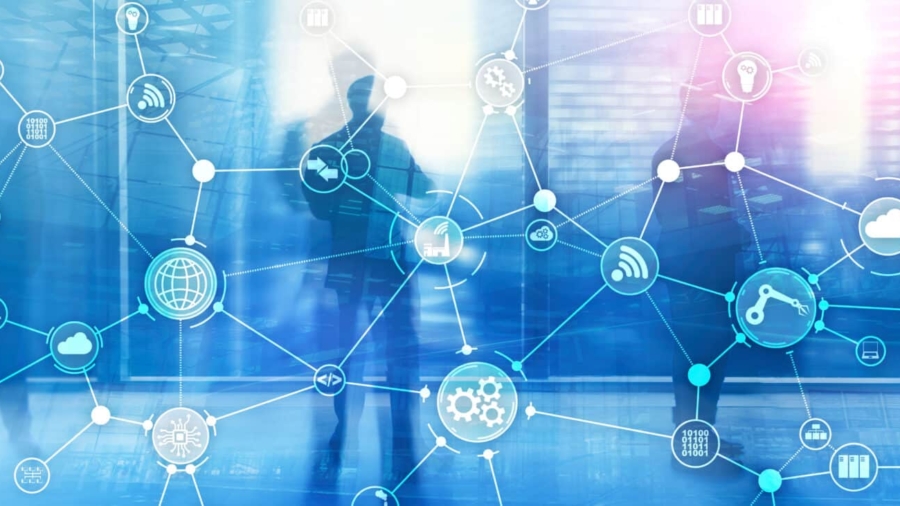 Silhouettes of business people stand in a modern office. A digital network of interconnected icons, including gears and graphs, is overlaid, symbolizing technology, data, supply chain execution software, and global connectivity.