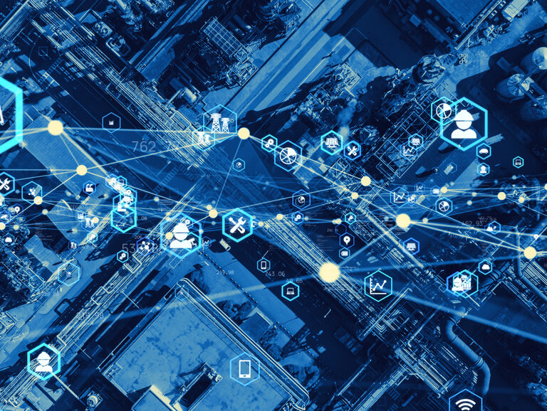 Aerial view of an industrial facility overlaid with digital icons and network lines, symbolizing data connectivity, supply chain optimization, smart technology, and industrial automation. The color scheme is predominantly blue.