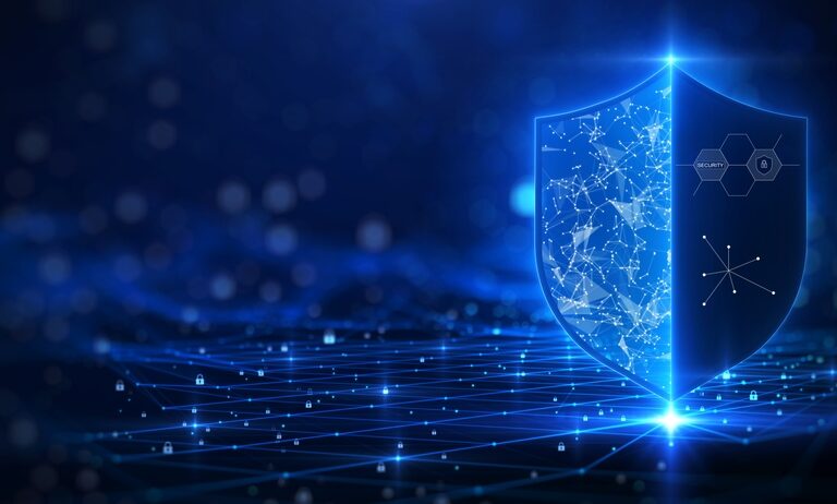 A glowing digital shield with network and security icons stands on a futuristic grid, symbolizing cybersecurity, Microsoft application management, and data protection on a blue tech-themed background.
