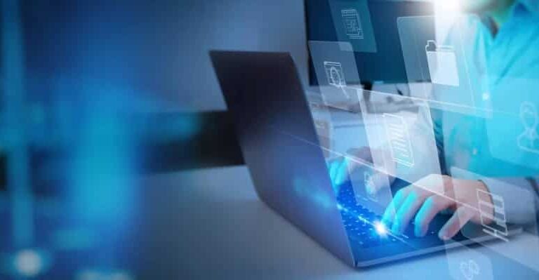 A person in a blue shirt types on a laptop, with translucent digital icons like folders, locks, and a clock floating above the keyboard, suggesting cybersecurity or digital data management.