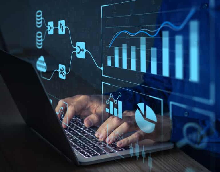 Person typing on a laptop with transparent digital graphs, charts, and ERP data flow diagrams displayed in the foreground, representing advanced data analysis or business analytics.