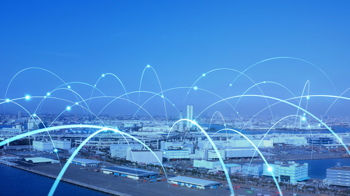 A cityscape with a harbor, overlaid with glowing blue arcs representing digital connections or data networks, illustrating the concept of smart cities or modern connectivity.
