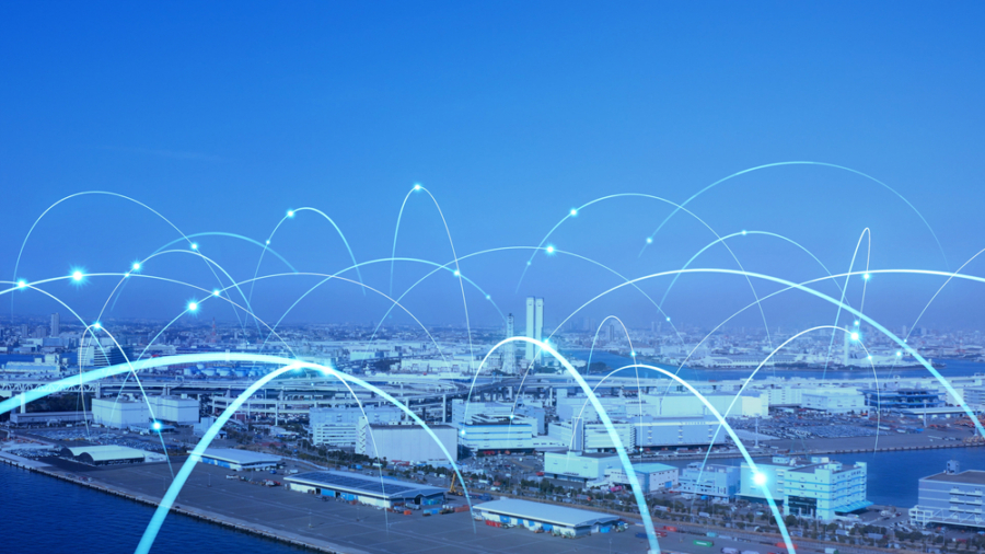 A cityscape with a harbor, overlaid with glowing blue arcs representing digital connections or data networks, illustrating the concept of smart cities or modern connectivity.