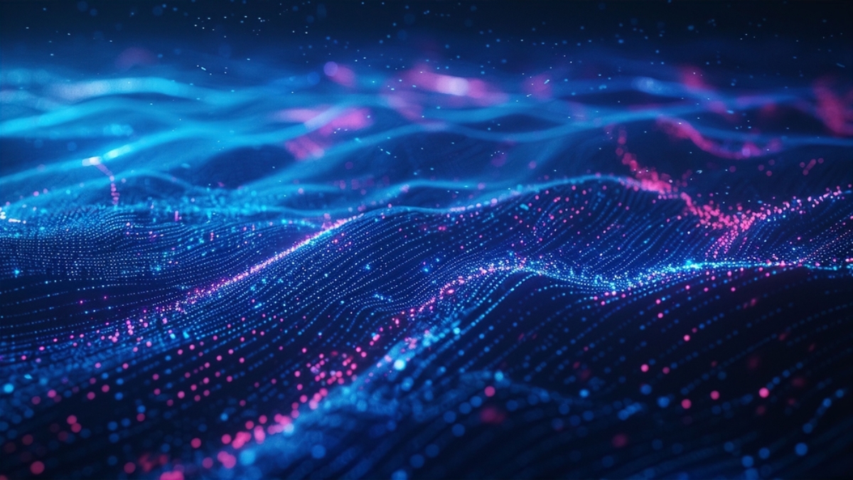 A digital illustration of abstract, glowing blue and pink waves, resembling a data network or energy field—ideal for visualizing concepts like wireless assessment—with numerous light particles scattered across a dark background.