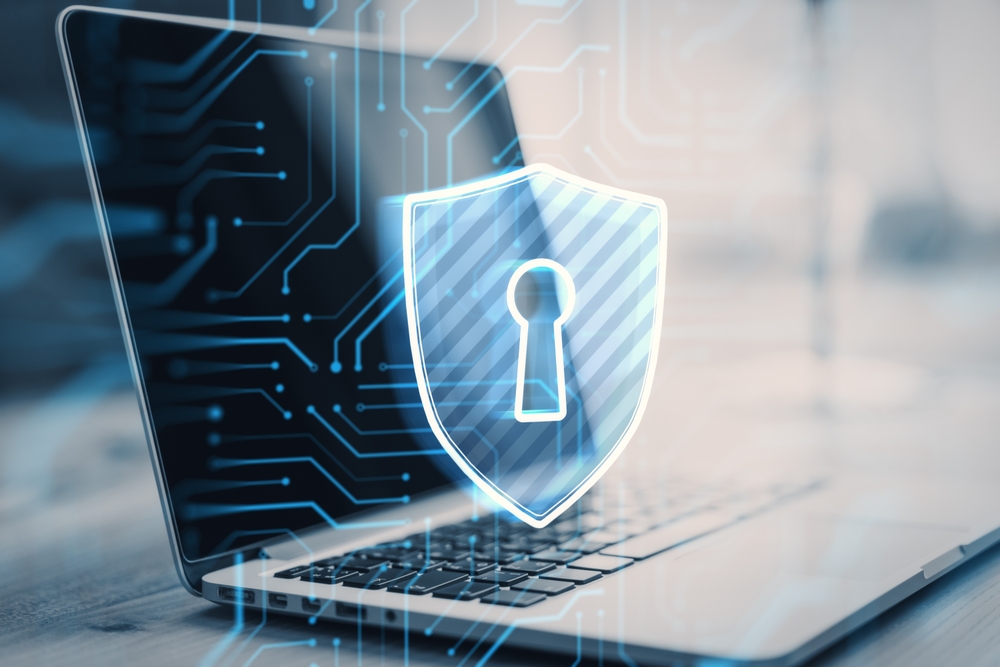 A laptop with a glowing digital shield and keyhole icon overlay, representing cybersecurity and data protection, highlights enVista Careers opportunities, with circuitry patterns in the background.