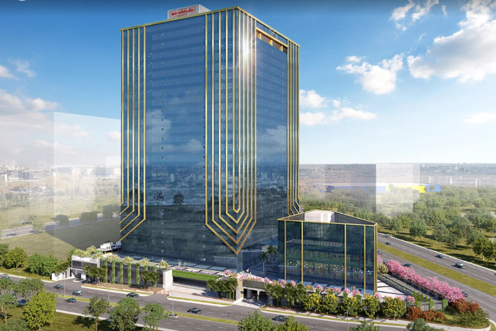 A tall, modern glass office building with gold accents stands beside a smaller matching structure—home to enVista Careers and parcel audit service—surrounded by greenery and roads under a bright, partly cloudy sky.